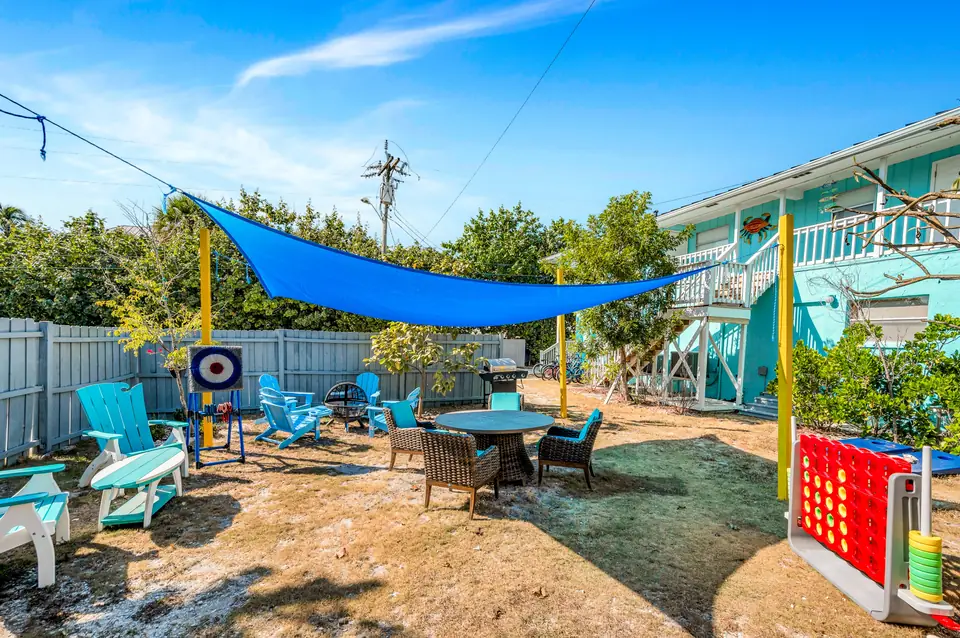 Backyard with lawn games and shaded seating